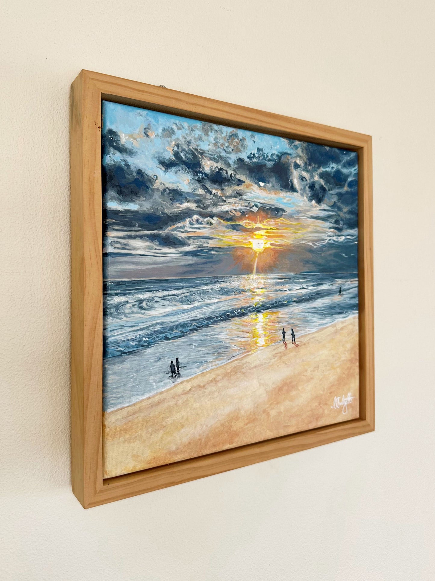 A fine art print of an oil painting depicting a sunset over Seminyak Beach, Bali, with figures on the beach and moody colors in the sky.