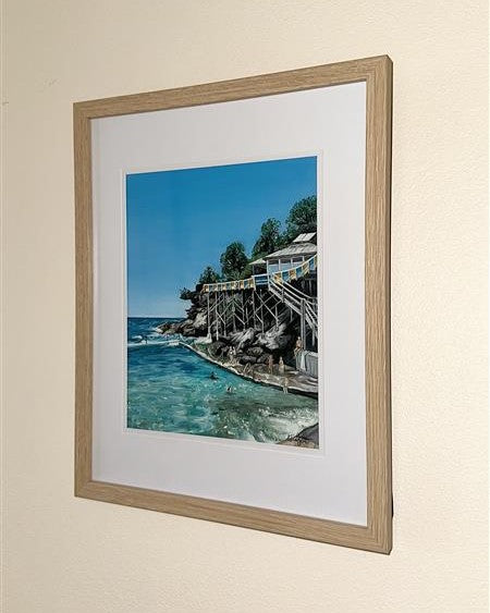 A fine art print of an oil painting depicting Wylie's Baths and Coogee Beach, featuring clear blue sky, ocean, and a man-made bath structure with people in the water. One of the most iconic beaches in Sydney.